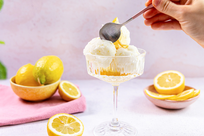 Zitronensorbet in einer Dessertschale mit frischen Zitronen