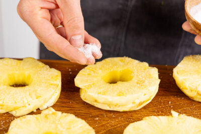 Ananas mit Salz und zucker bestreuen