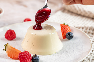Fruchtsauce auf die Panna cotta geben